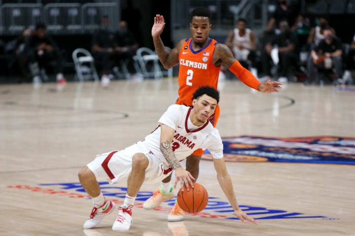 Dec 12, 2020; Atlanta, Georgia, USA; Alabama Crimson Tide guard Jahvon Quinerly (13) dribbles defended by Clemson Tigers guard Al-Amir Dawes (2) in the first half of a Holiday Hoopsgiving game at State Farm Arena. Mandatory Credit: Brett Davis-USA TODAY Sports